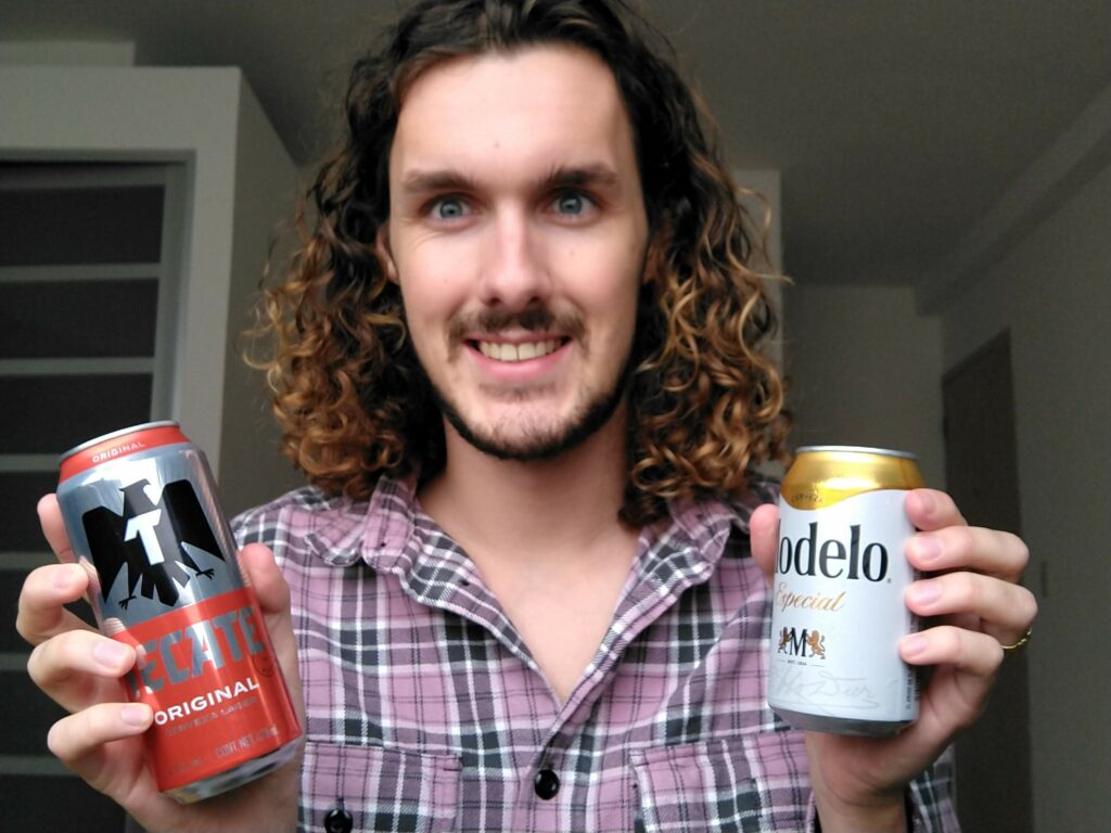a man holding tecate original and modelo especial cans