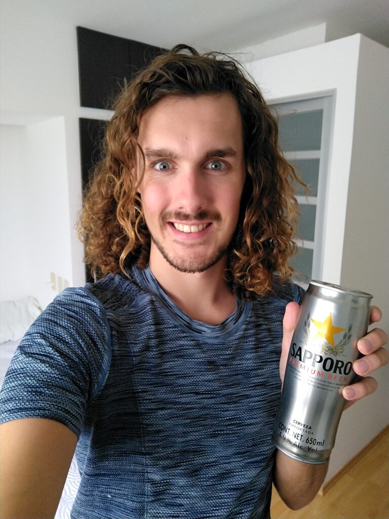 Stefan, the founder of Beveragebeaver.com, holding a can of Sapporo beer