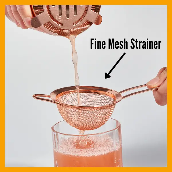 A Fine Mesh Strainer being used to make a cocktail.