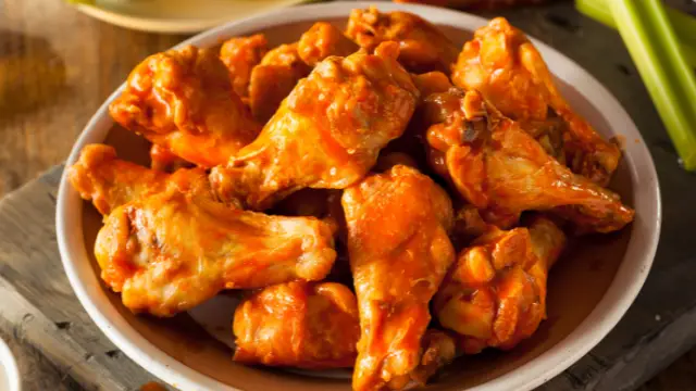 A close up of some buffalo Chicken wings on a plate