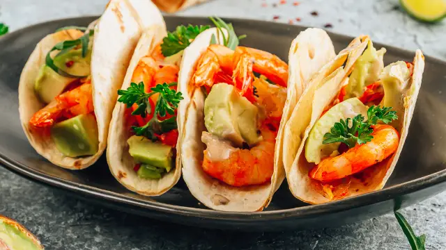 A close up of some shrimp tacos on a plate