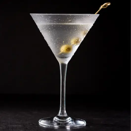 A Vodka Martini cocktail on a black background.