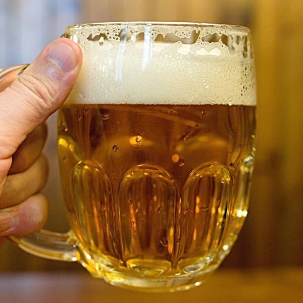 A hand holding a Czech Pilsner