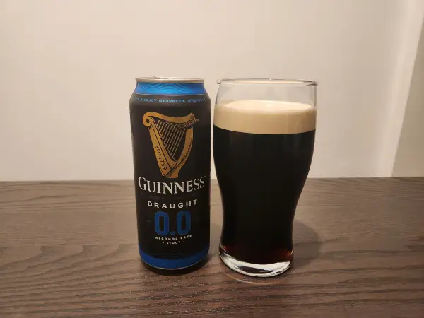 A pint of Guinness Zero Next to an empty can.