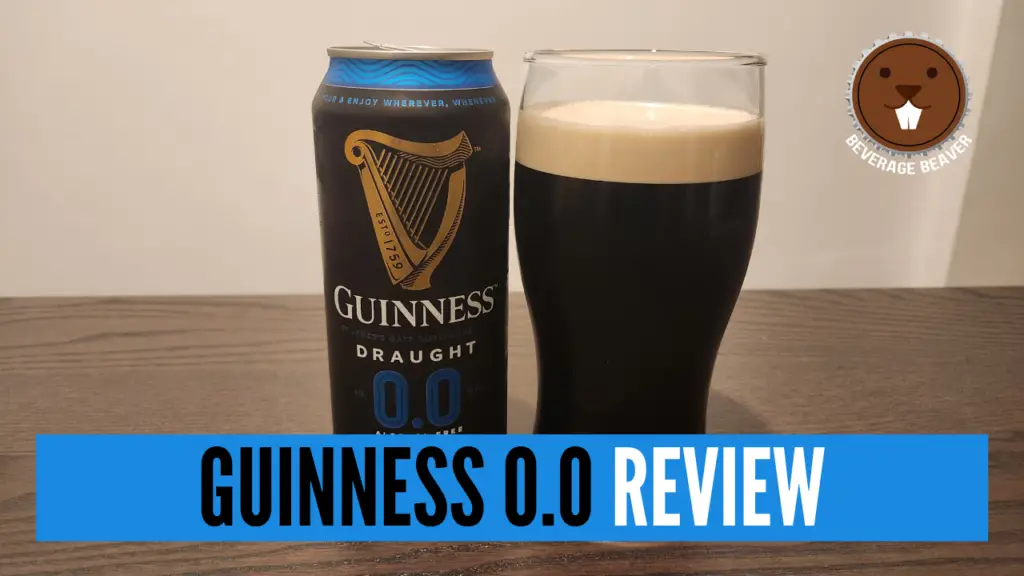 A can of Guinness Zero Next to A Pint Of Guinness Zero on a table