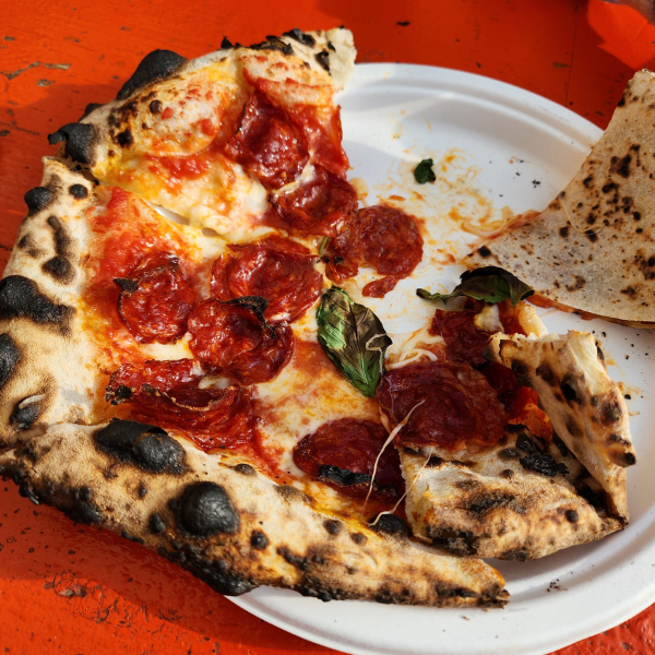 A Pepperoni Pizza on a paper plate