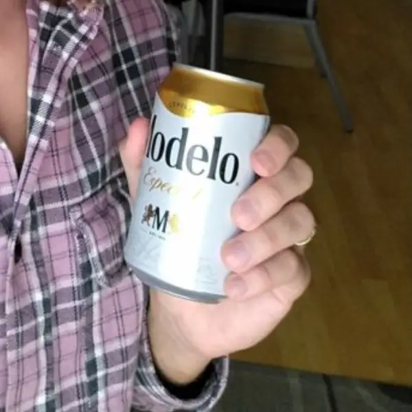 A hand holding a Modelo Especial Beer Can